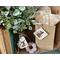 Handmade birch bark tags. One decorates a vase and the other is tied to a kraft gift bag with a piece of natural twine.